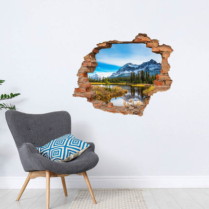 Wandaufkleber Wandtattoo in Form eines Wanddurchbruchs  von Italienischen Bergen als Hauptbild neben einem grauen Sessel