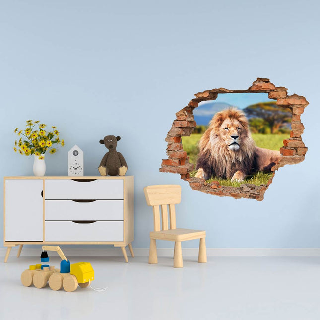 Wandaufkleber Wandtattoo in Form eines Wanddurchbruchs  von einem Löwen als Hauptbild im Kinderzimmer neben der Kommode