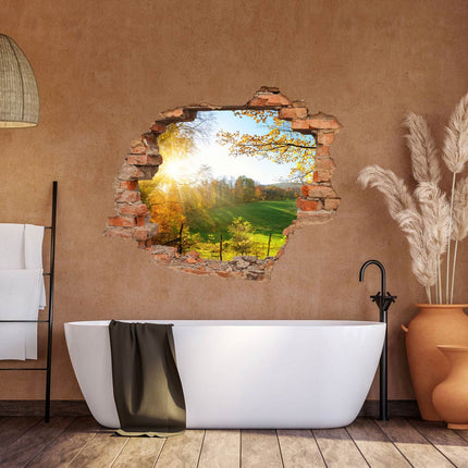 Wandaufkleber Wandtattoo in Form eines Wanddurchbruchs  von einer Waldlichtung als Hauptbild im Badezimmer an einer orangenen Wand über der Badewanne